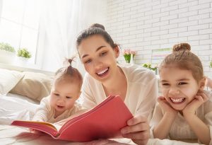 A mom happily reading to child