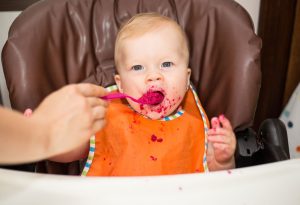 Baby eating beetroot