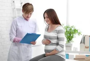 A young pregnant woman visiting a doctor