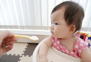 A baby eating yogurt