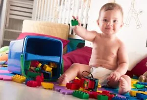 A 7-months-old baby stacking blocks