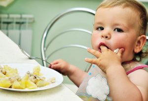 11-month-old baby eating finger food