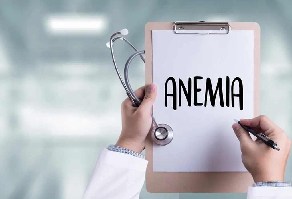 A doctor writing anaemia on sheet