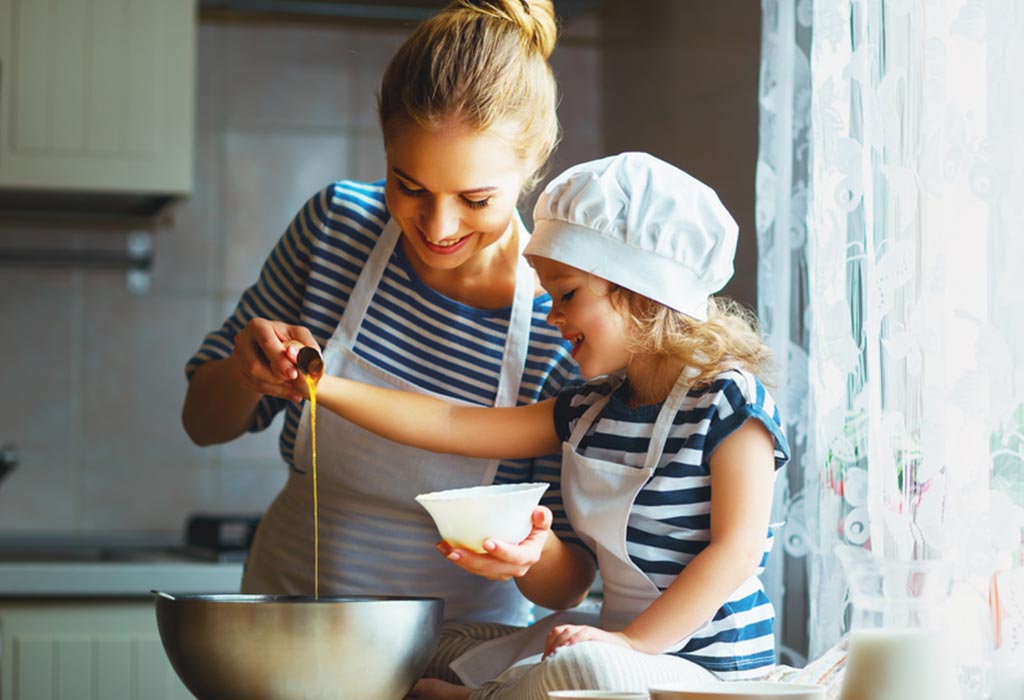 A mother and daughter cooking in the kitchen