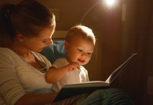MOTHER READING OUT TO BABY