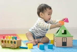 A none month-old baby playing all by himself