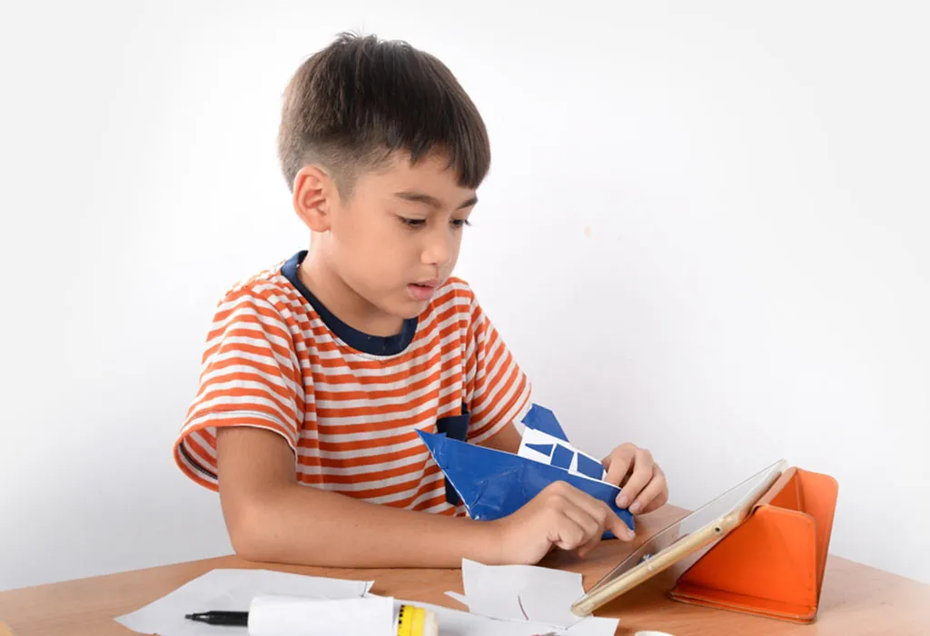 A boy folding paper