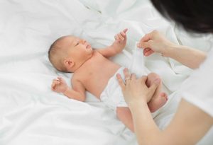 Changing the diaper of a newborn baby