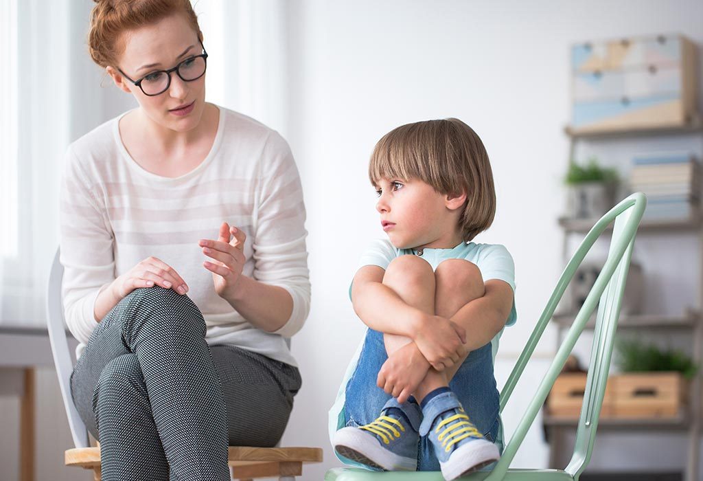 A therapist talking to a child