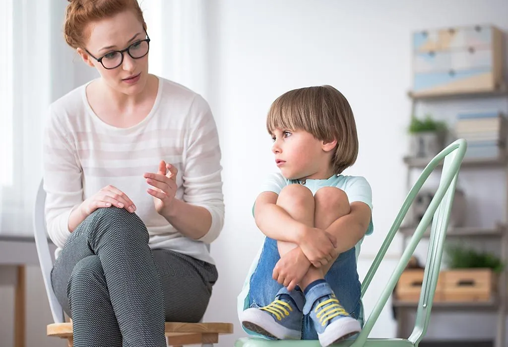 A therapist talking to a child