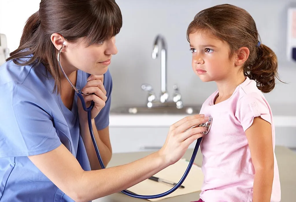 A doctor examining a little girl