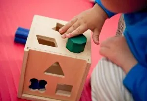 A baby playing with shapes-learning toys