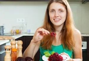 A woman eating beetroot