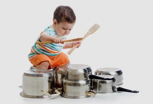 A child drumming on pans and pots