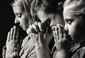 Family praying together - Respecting Religion