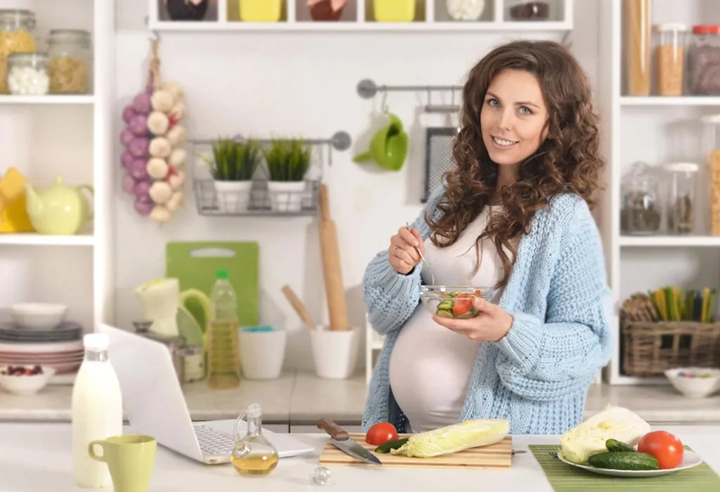 A pregnant woman with a bowl of food in her hand