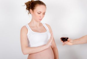 A pregnant woman saying no to alcohol