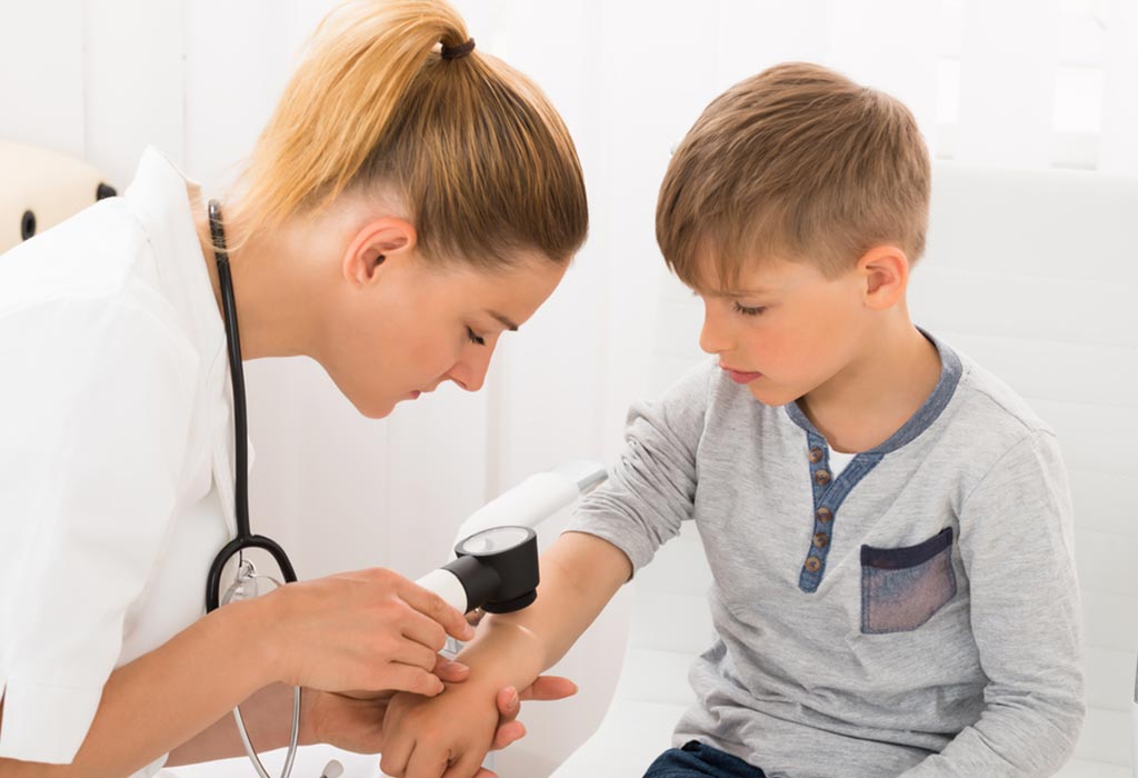 A doctor examining a young boy