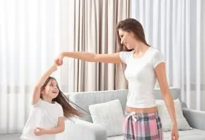 A mother and daughter dancing together