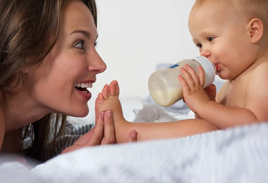 Age baby holds sales bottle