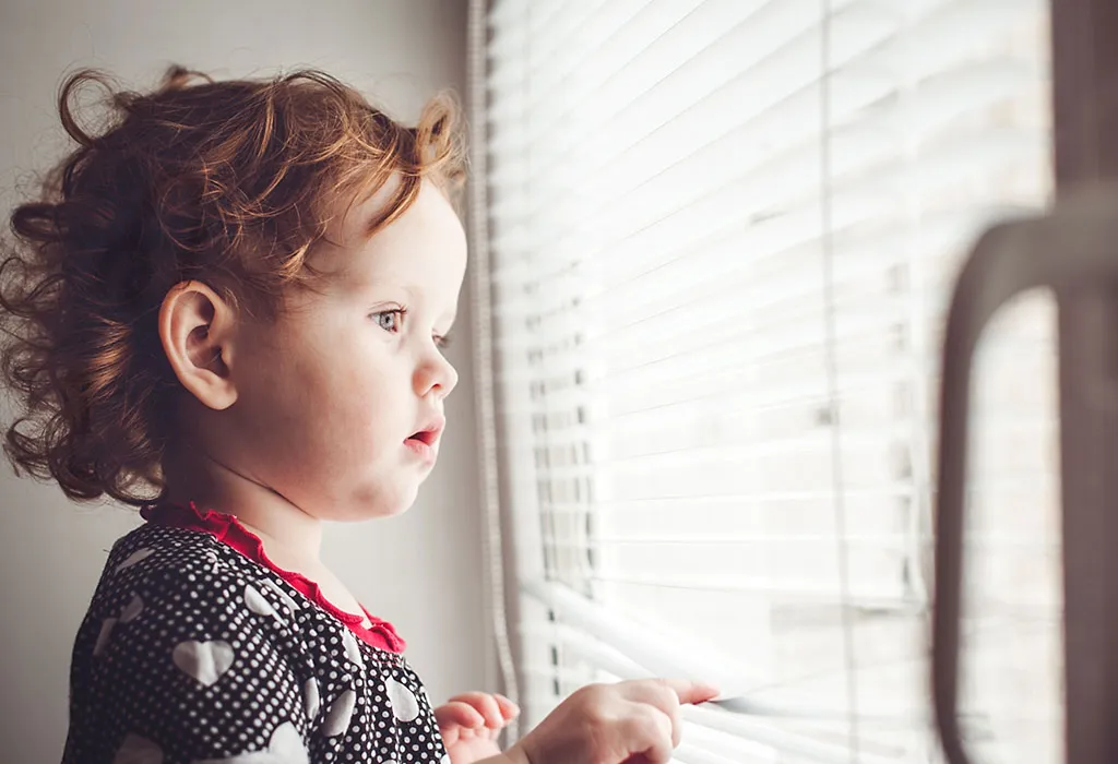 Baby girl looking out of window