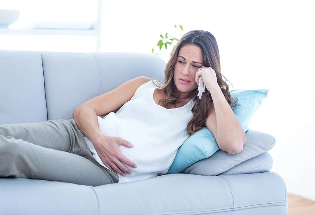 A pregnant woman crying