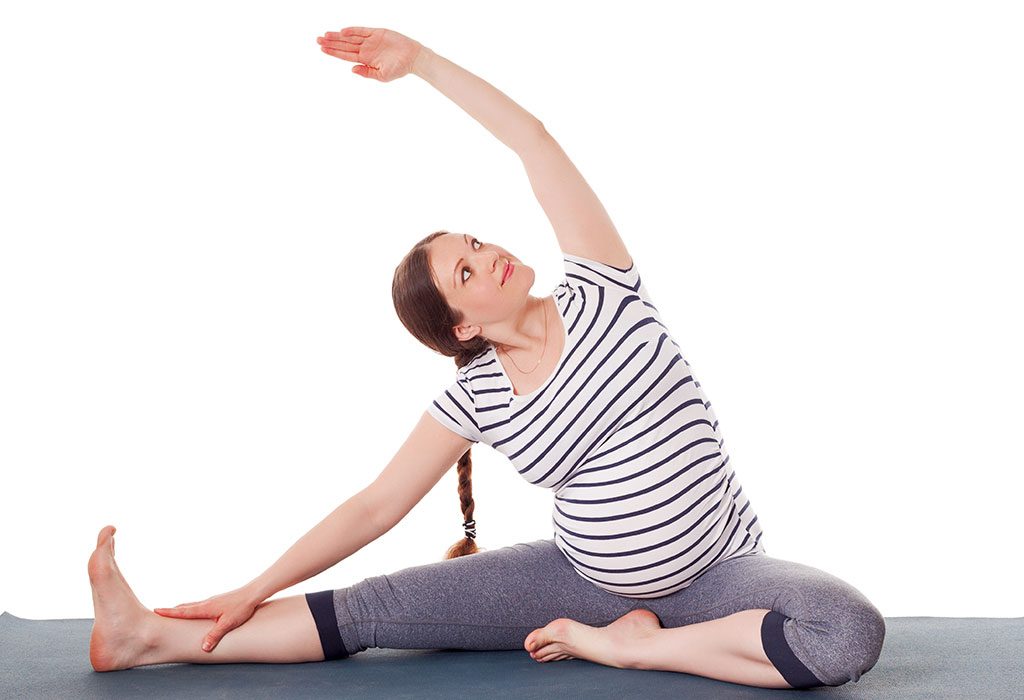 A pregnant woman doing Yoga