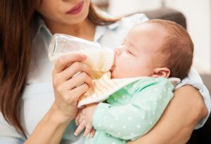 A newborn drinking milk from bottle