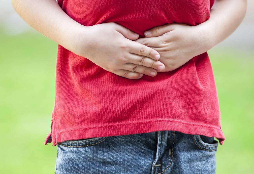 A little boy holding his stomach