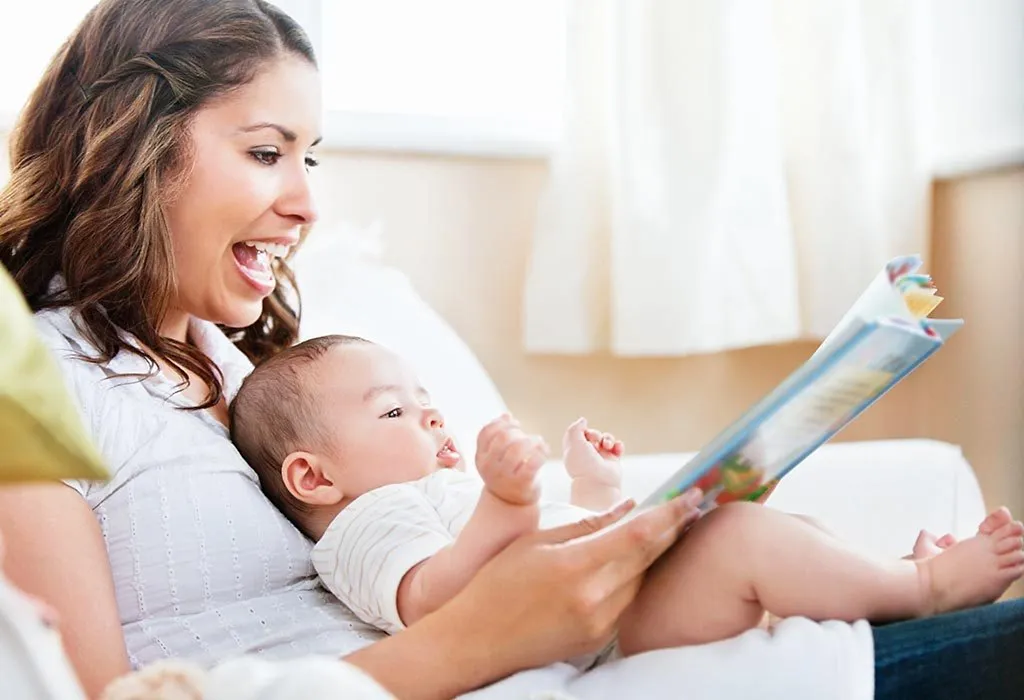 A mother reading a book to her baby