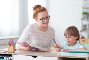 A woman teaching a girl with dyslexia