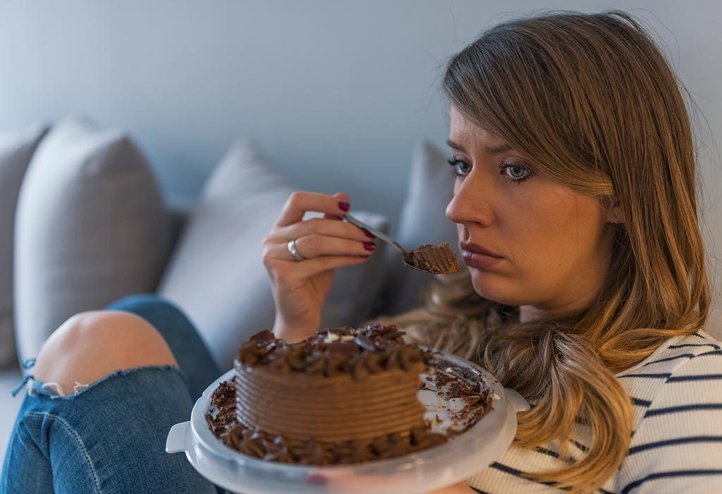 A sad woman eating cake