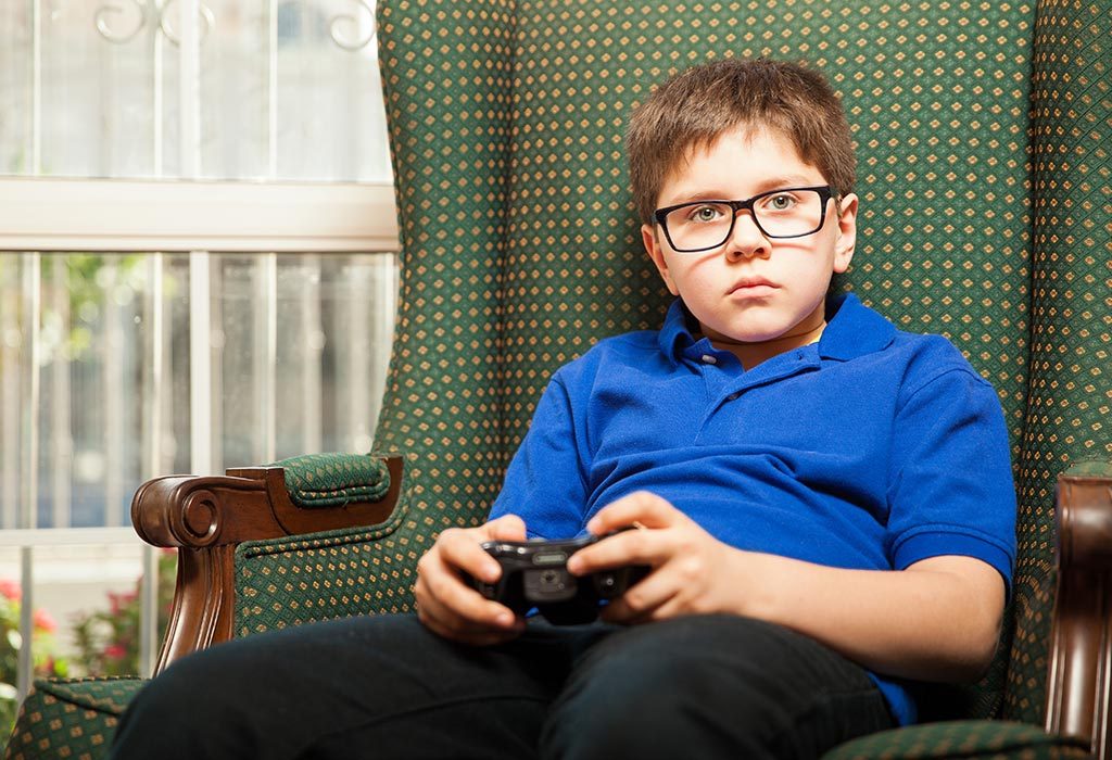 A sad boy playing video games