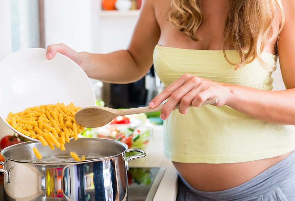 Pregnant woman making pasta