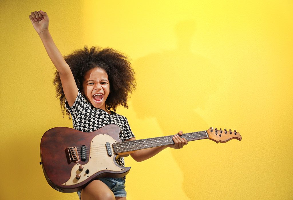 A little girl playing the guitar