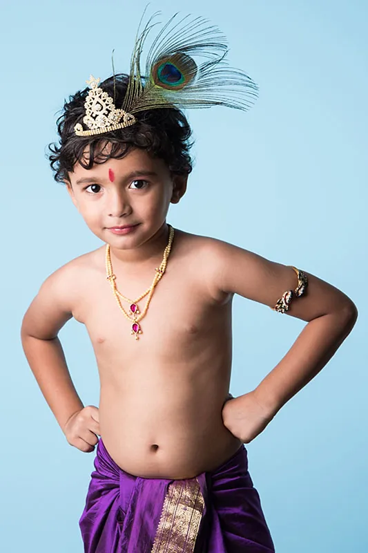 A boy dressed as Lord Krishna