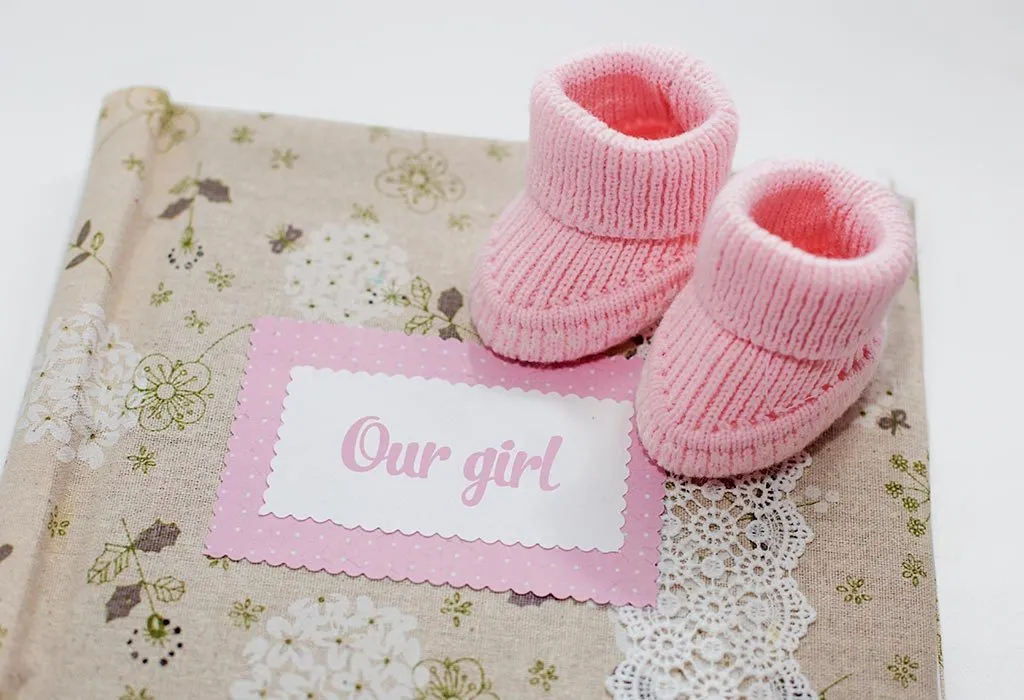 Pink baby shoes on a mat