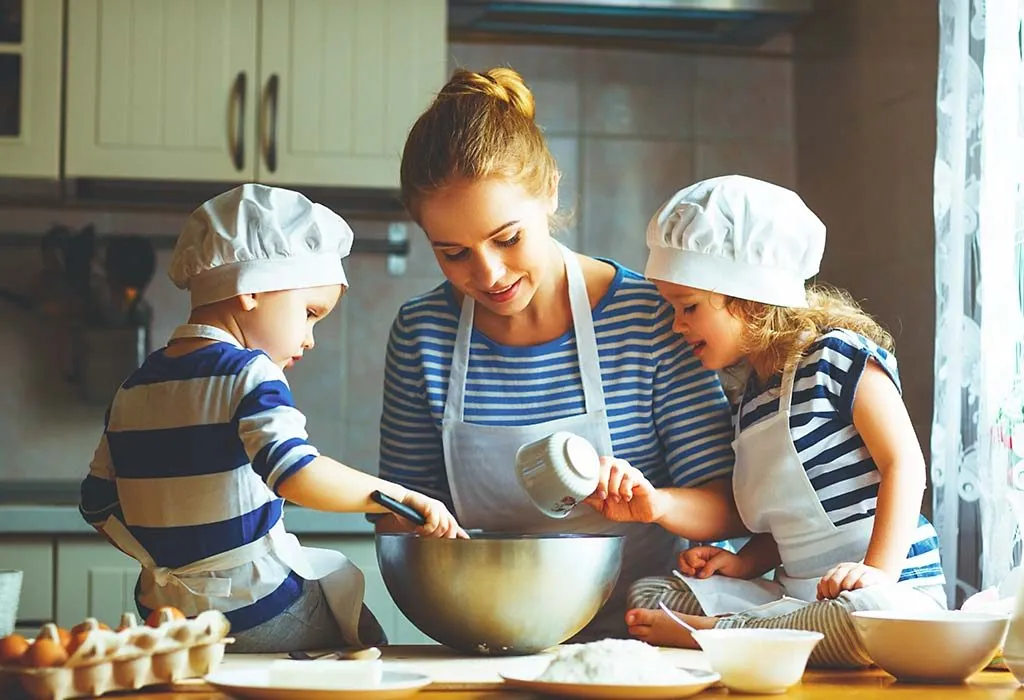 Children baking a cake with their mother