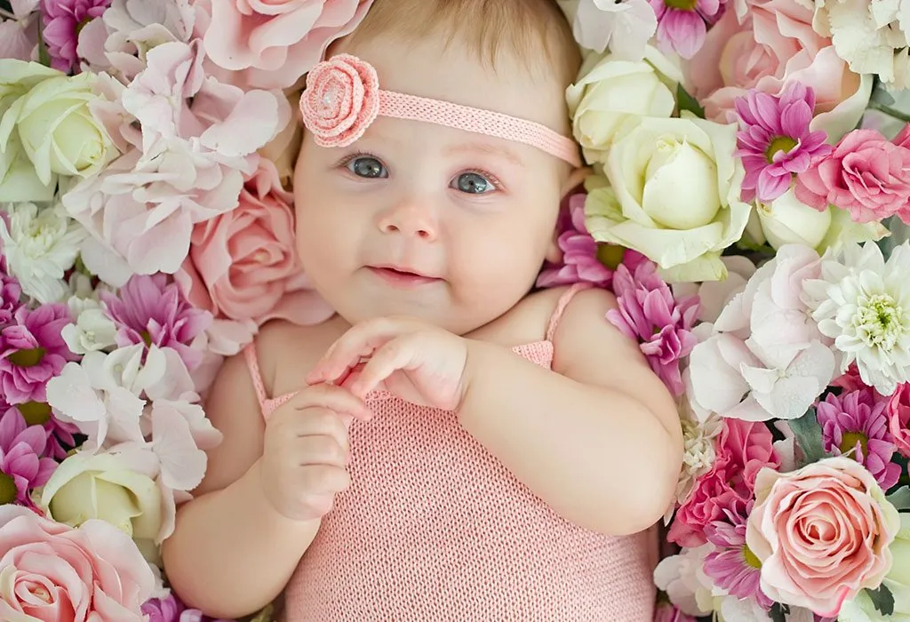 A baby girl surrounded by flowers