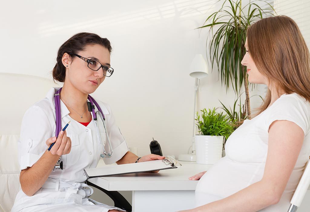 A pregnant woman talking to a doctor