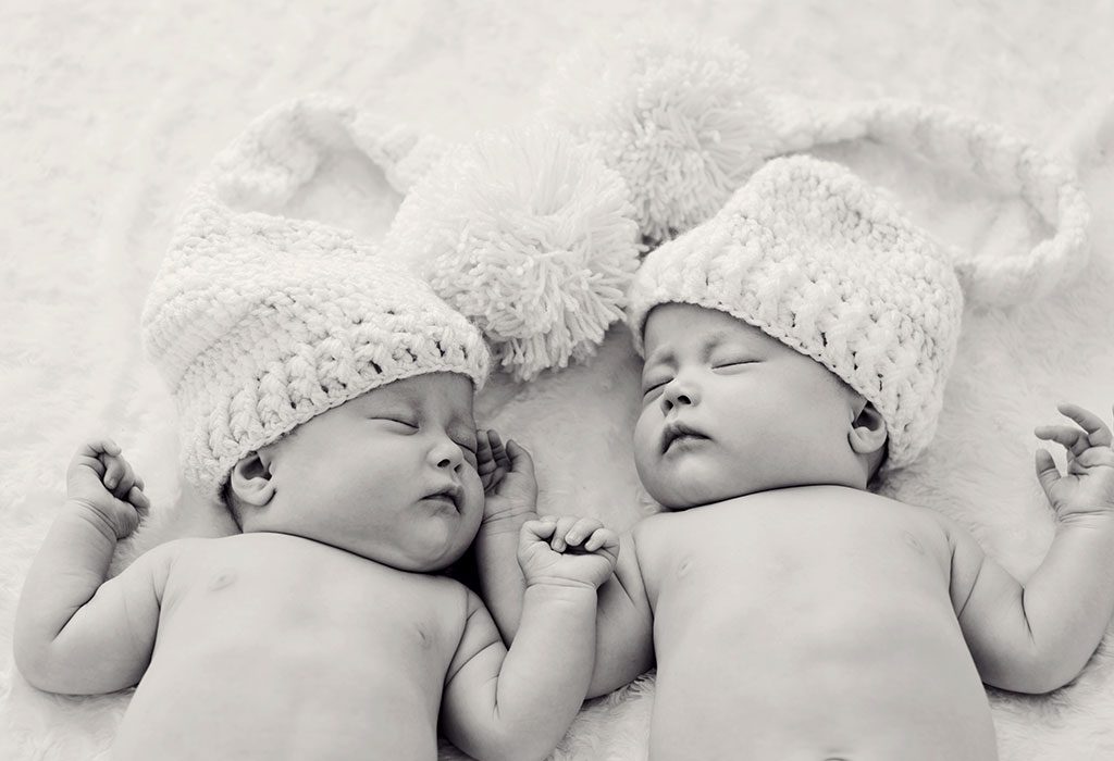 Twins sleeping in outlet same crib