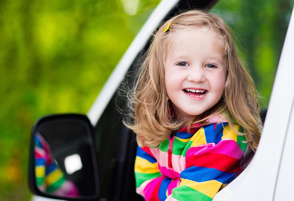 A girl sitting in the front seat of a car