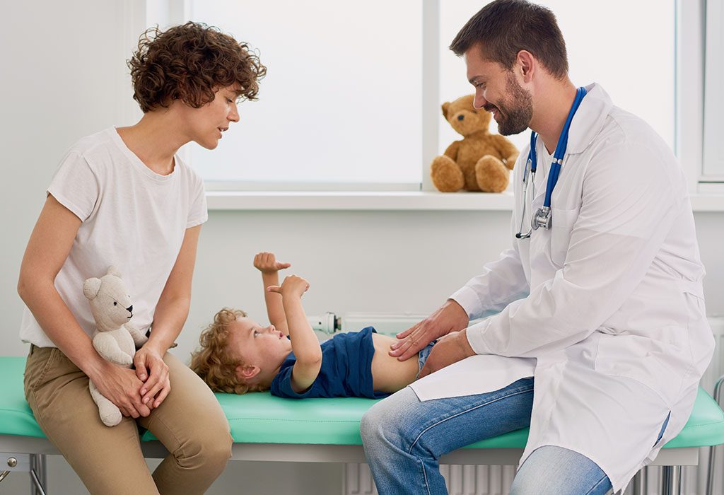 A doctor examines a child's stomach