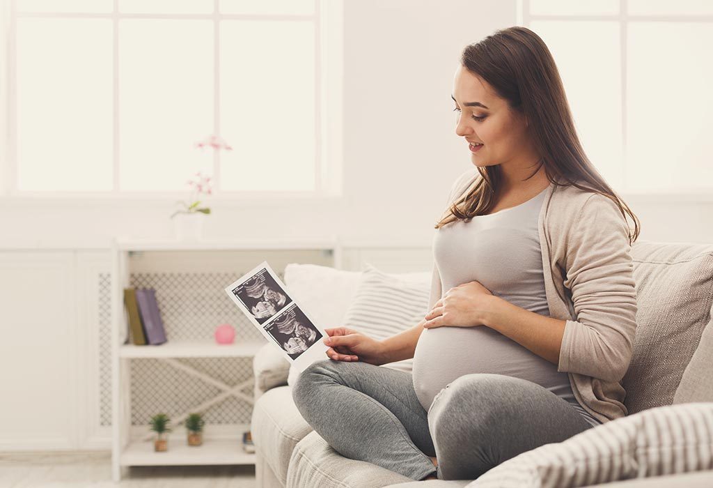 A pregnant woman looks at the ultrasound scan