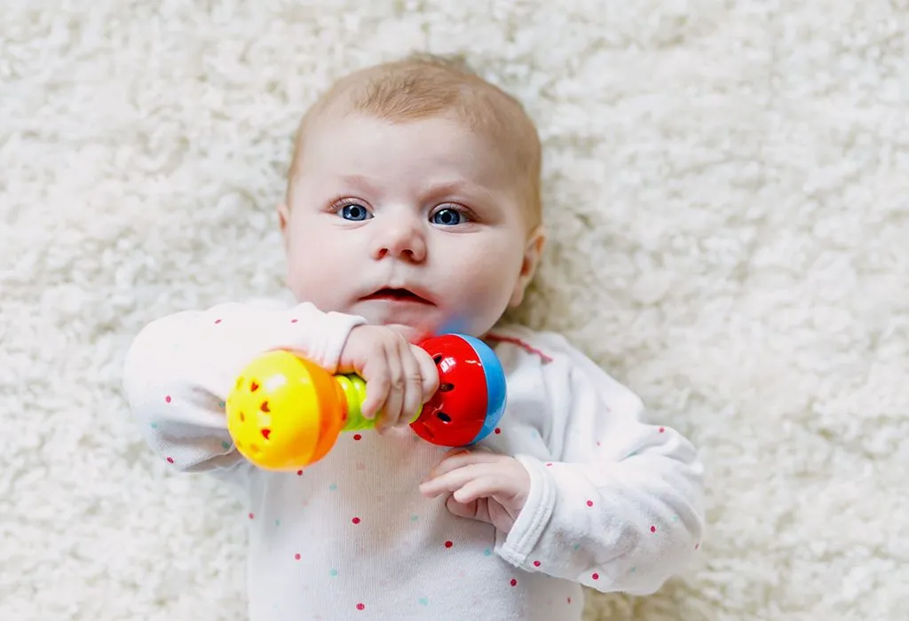 Baby playing with rattle