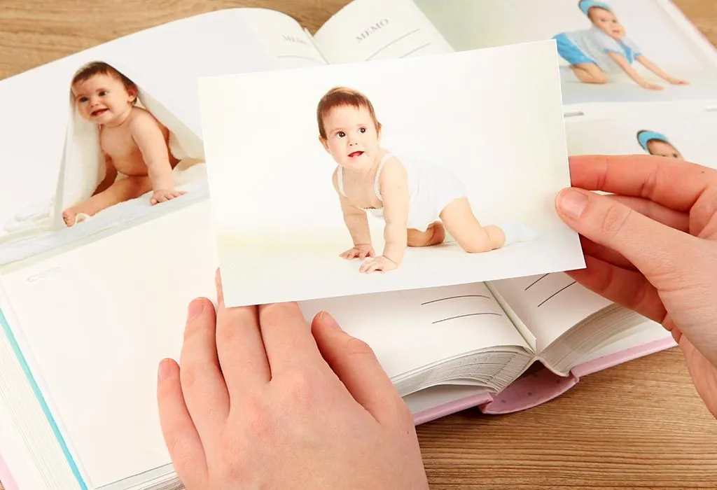 A mother sticks her baby's pictures in an album