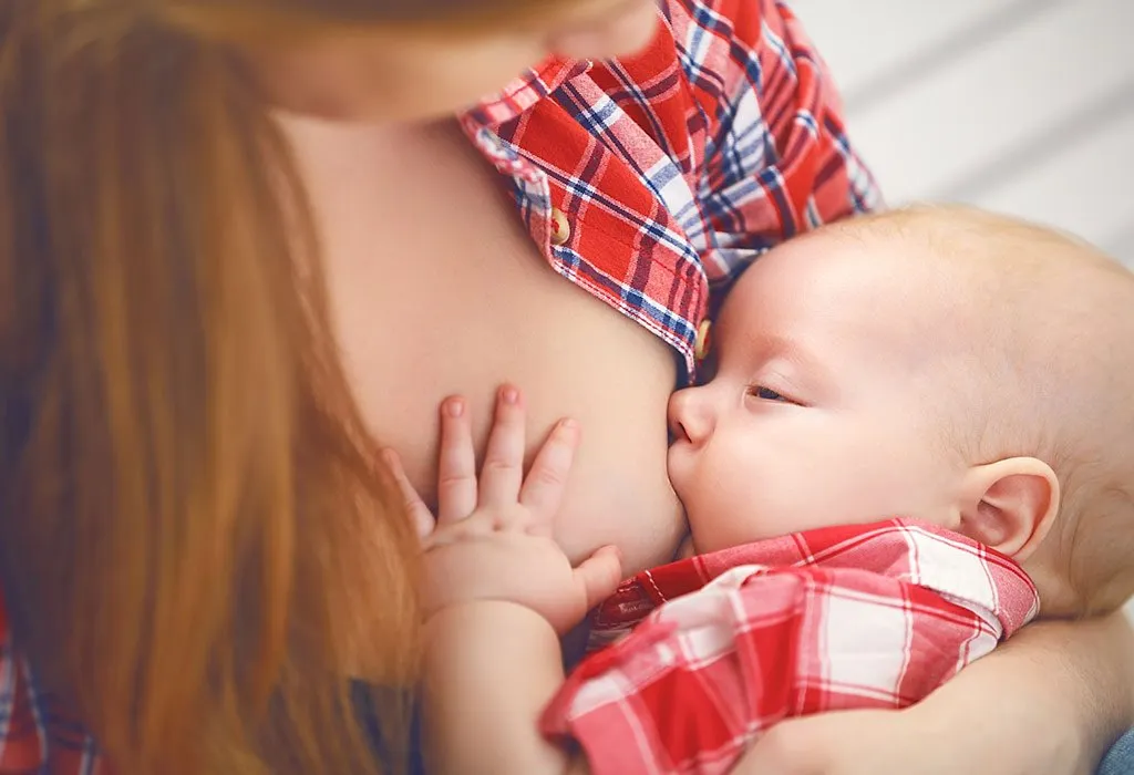Baby comfort nursing at mother's breast>