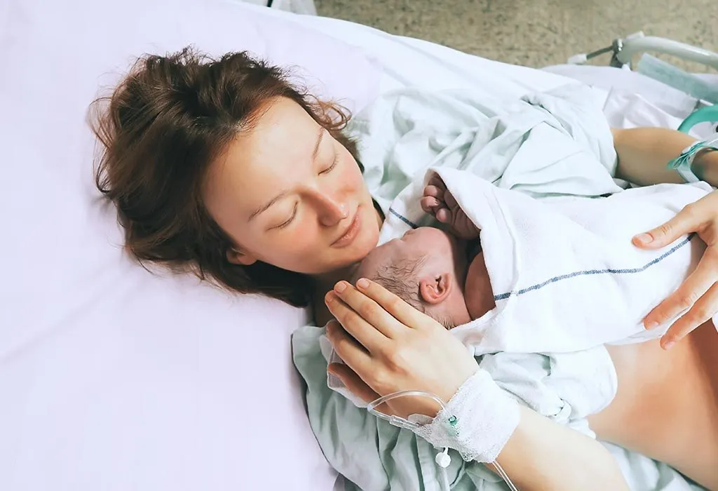 Mother holds newborn after delivery