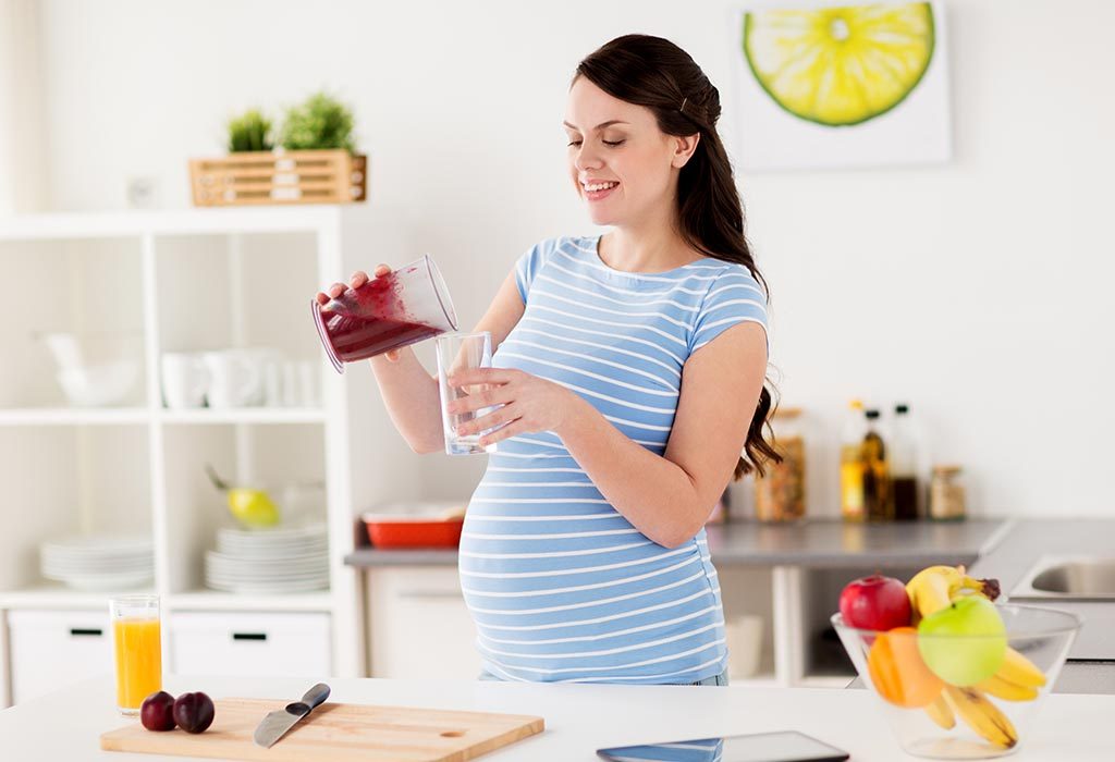 A pregnant woman makes plum juice