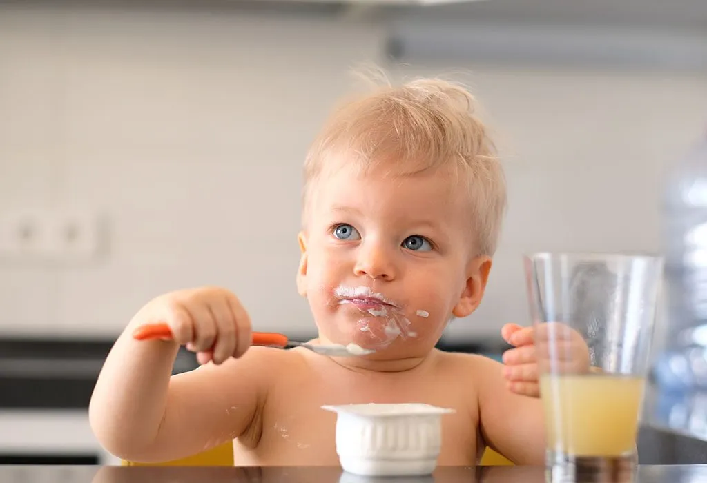 Toddler eating yoghurt